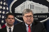Attorney General William Barr, right, next to FBI Deputy Director David Bowdich, speaks during a news conference.