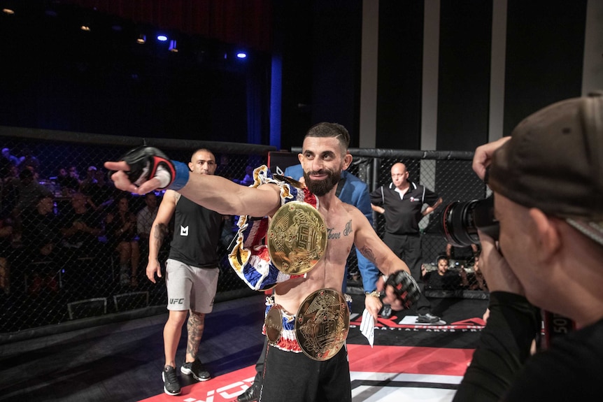 A man points while in the octagon at an MMA fight.