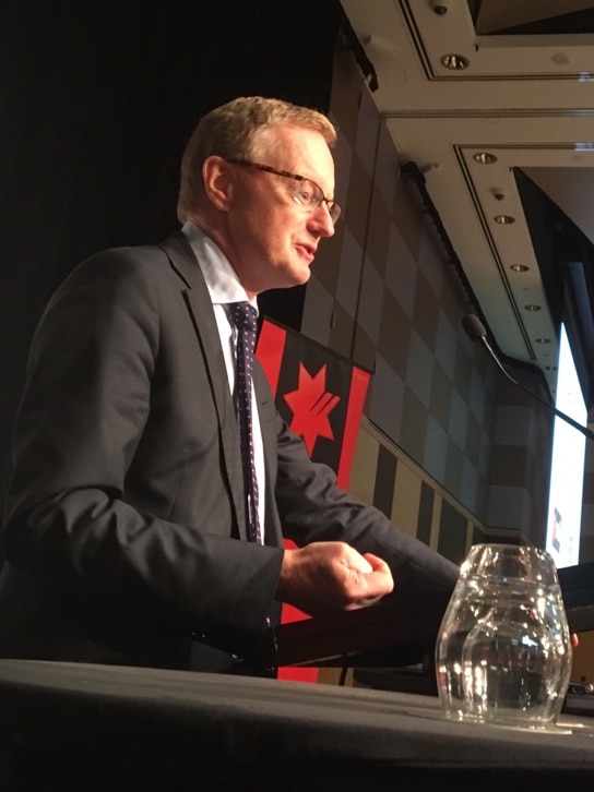 RBA governor Philip Lowe speaks at a podium