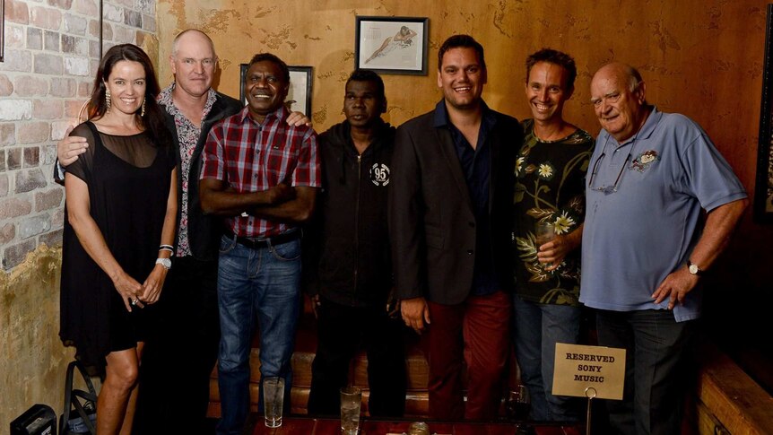 Group photo of woman, men and aboriginal musicians.