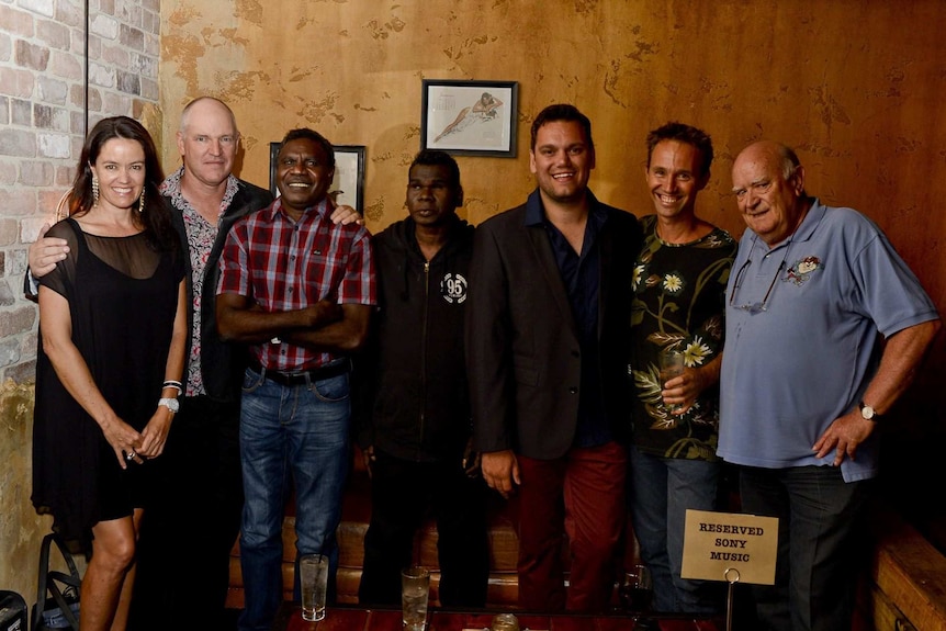 Group photo of woman, men and Aboriginal musicians.
