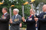 Veterans with the RSL Anzac Flame at the Australian War Memorial in Canberra.