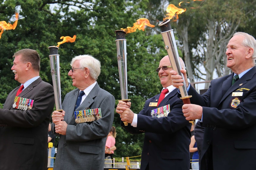 Veterans with the RSL Anzac Flame at the Australian War Memorial in Canberra.
