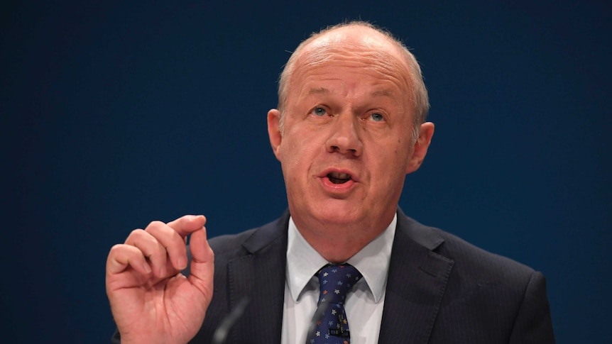 Damian Green gestures with his hand while speaking.