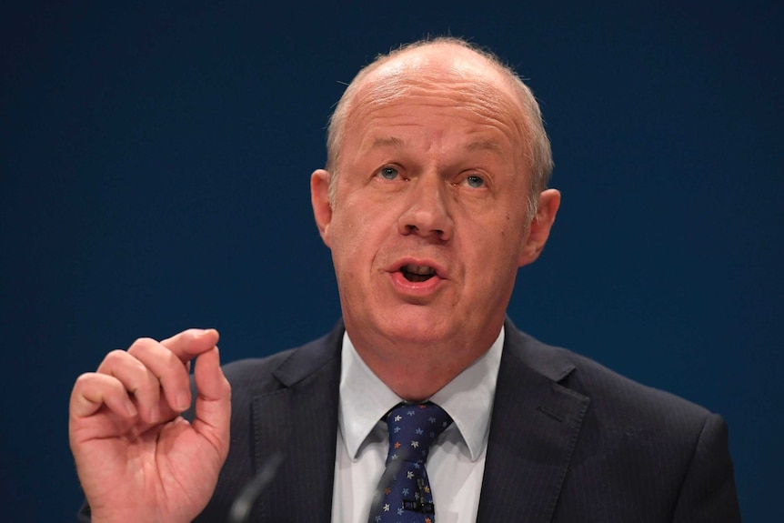 Damian Green gestures with his hand while speaking.