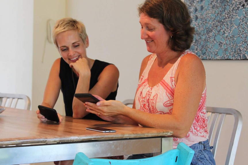 two women on smartphones