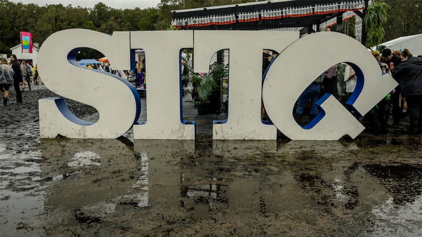 A lopsided SITG logo in the mud at Splendour In The Grass