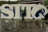 A lopsided SITG logo in the mud at Splendour In The Grass