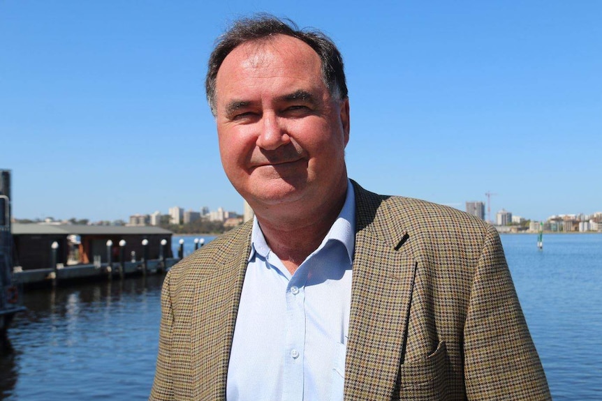 Mack stands in front of the water at Elizabeth Quay.