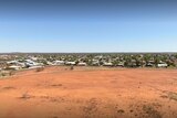 Aerial shot of small town with red dirt