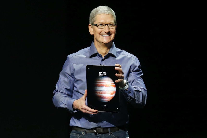 Apple CEO holds new Apple iPad Pro