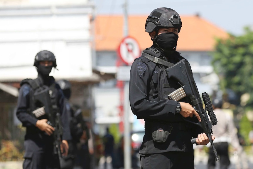 Police stand guard after explosion in Surabaya