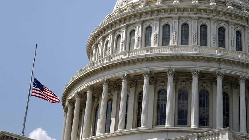 The flag over the US Capitol in Washington flies at half staff