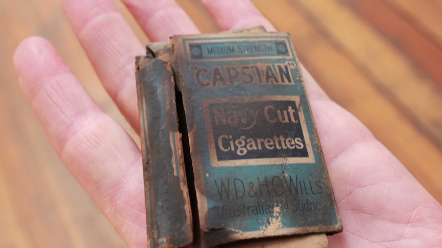 The old cigarette packet in the palm of a hand