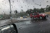 View looking out of car window while traveling in wet weather.