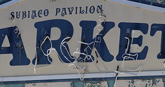 The Subiaco Pavilion Markets sign showing neon lighting hanging off it.