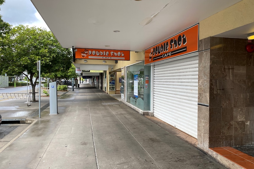 Empty street with closed shop fronts.