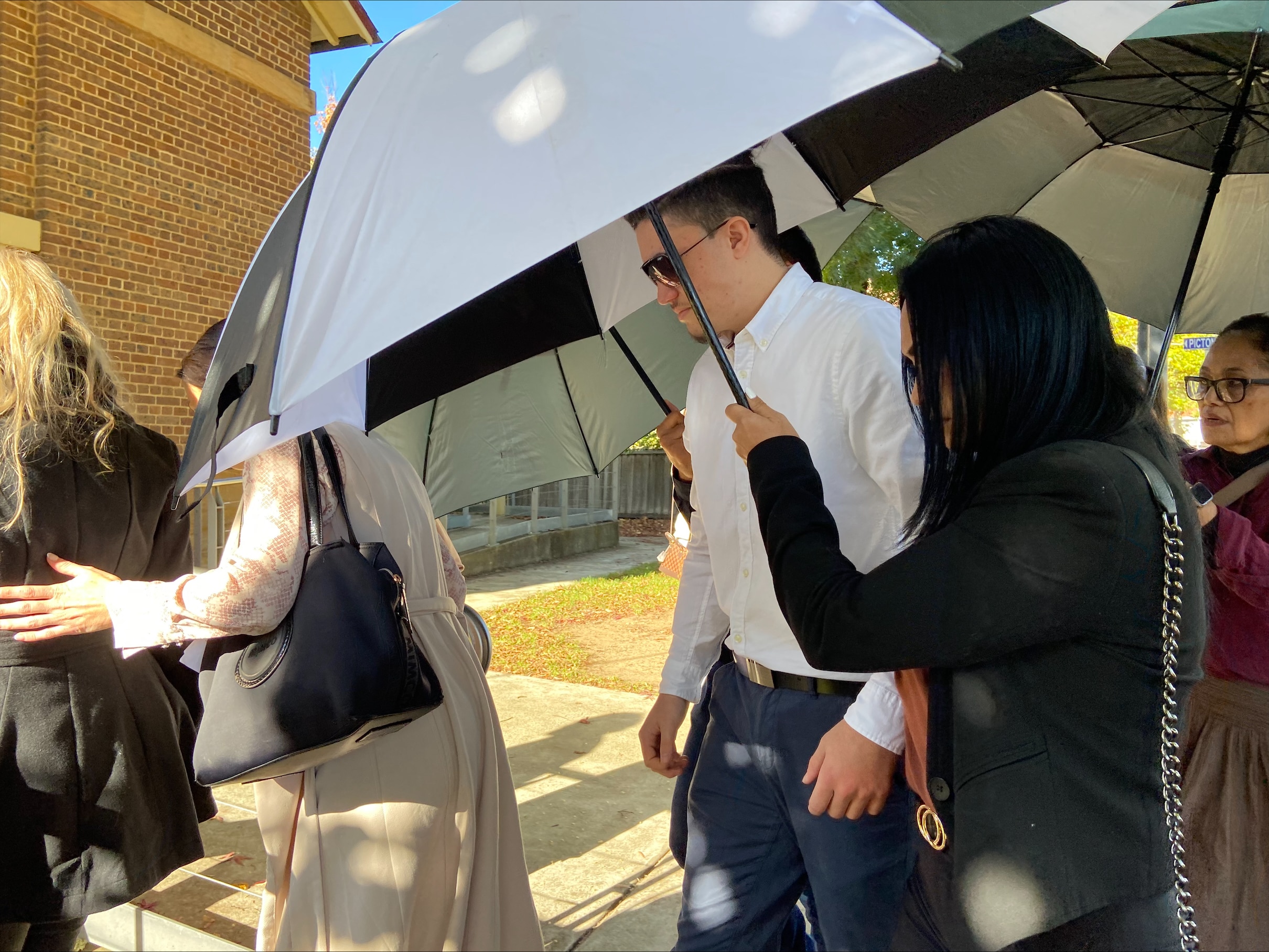 A group of people holding umbrellas