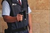 A security guard holds an ADE 651 'magic wand' bomb detector.