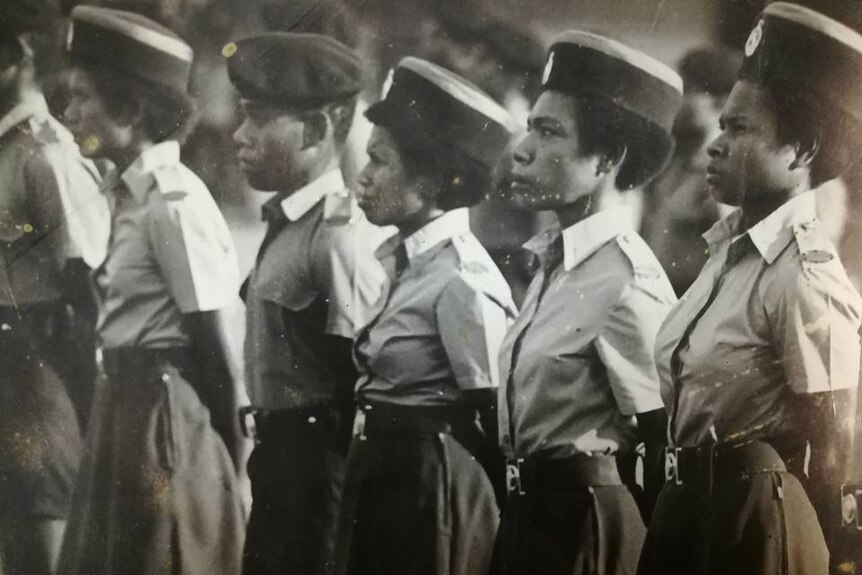 Black and white photo of PNG men and women in army uniforms