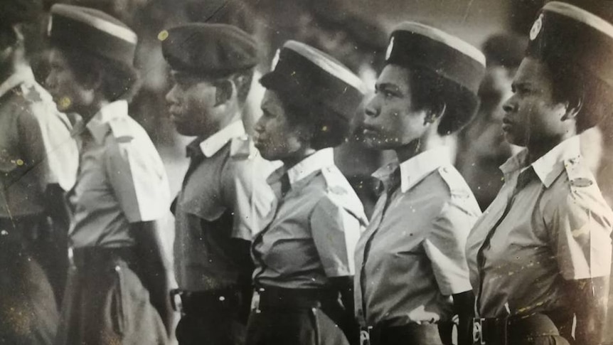 Black and white photo of PNG men and women in army uniforms