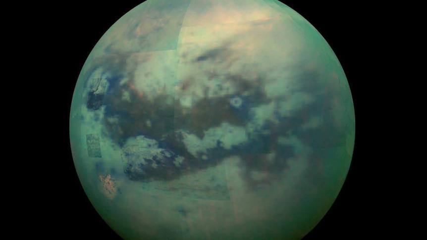 A patchwork view of a moon built from smaller images, in a greenish hue, with visible clouds.