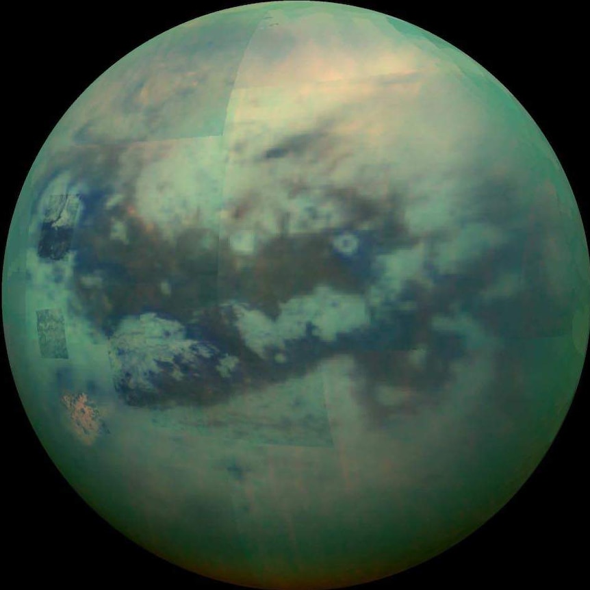 A patchwork view of a moon built from smaller images, in a greenish hue, with visible clouds.