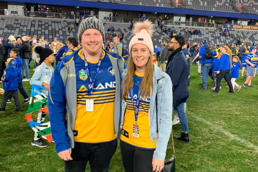 Parramatta fan Adam Martin stands alongside his wife Emma Martin