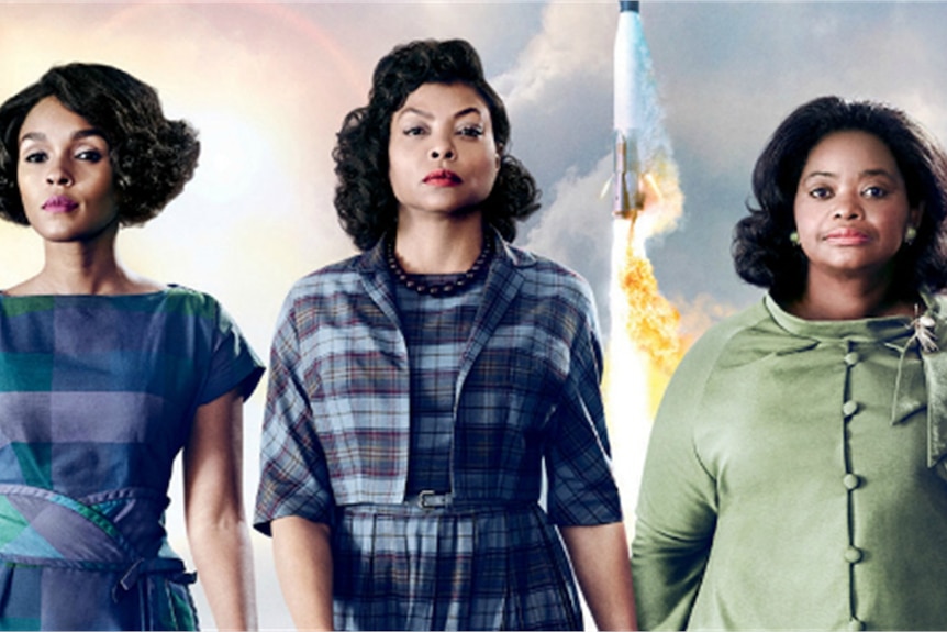 A scene from the film Hidden Figures.  Three African american women stand side-by-side in 1960s clothes.