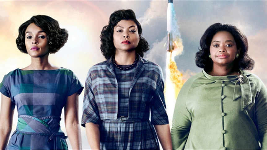 A scene from the film Hidden Figures.  Three African american women stand side-by-side in 1960s clothes.
