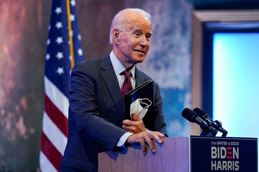 Joe Biden speaks at a podium.