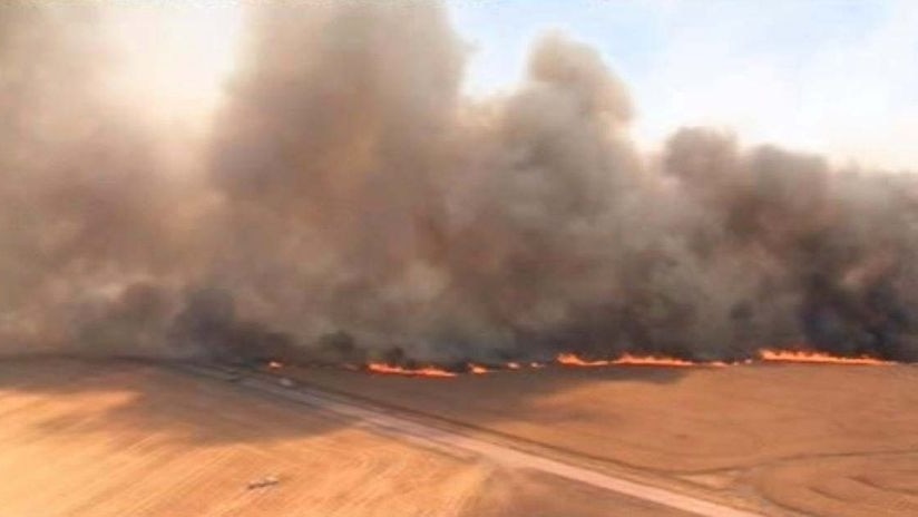 Dangerous: a fire burns in paddocks near Curramulka on the Yorke Peninsula