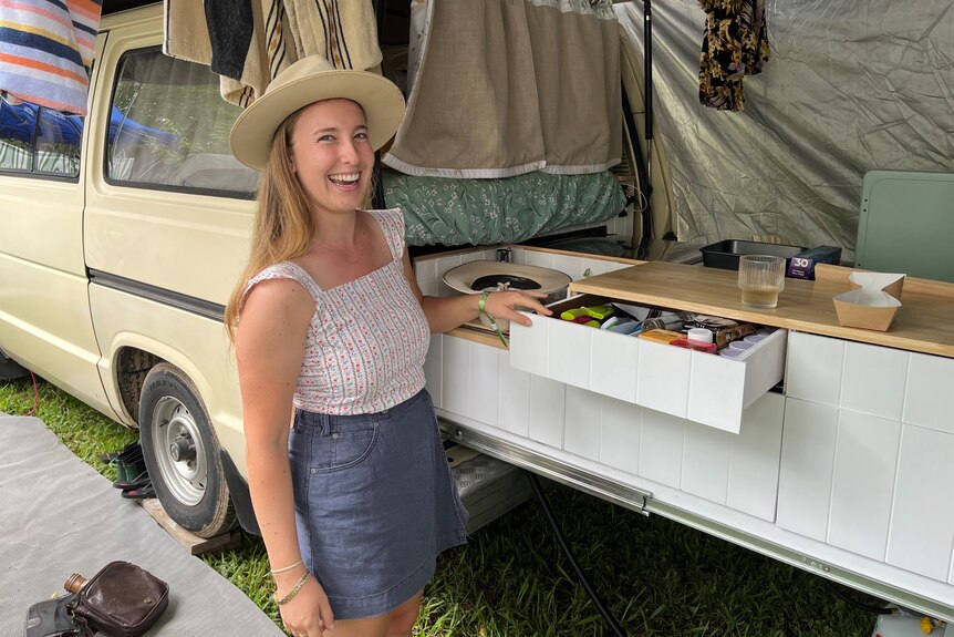 Ella Wickins stands next to her camper van at Woodford Folk Festival.