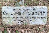 An old wooden grave marker which says 'in memory of Captain John Gogerly'.