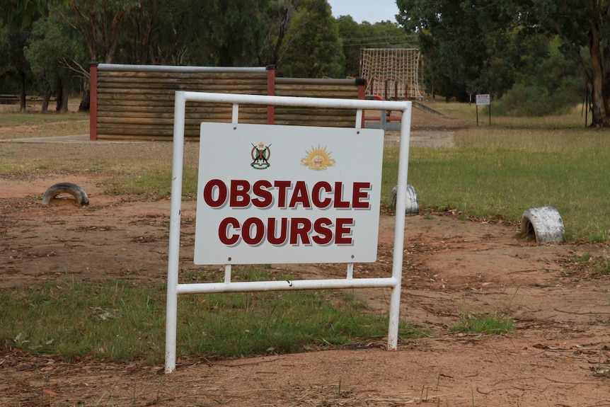 A picture of an obstacle course and sign