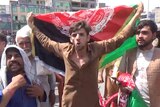 People carry Afghan flags as they take part in an anti-Taliban protest in Jalalabad, Afghanistan.