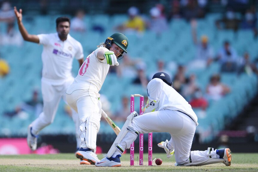 Australia batsman Will Pucovski looks back as India wicketkeeper drops the cricket ball. Bowler Ravi Ashwin looks on.
