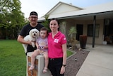 Jess Bussey, her partner Aaron and daughter Ivy in front of their home.