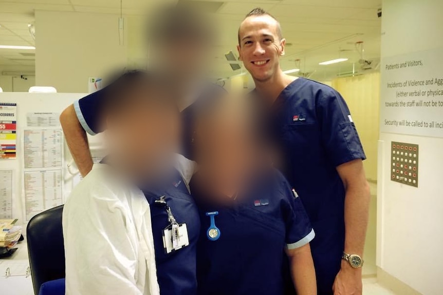 a group of four nurses, three with their faces blurred out, look at the camera