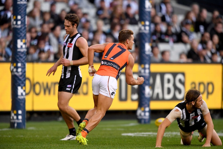 Zac Langdon of the Giants (C) celebrates after kicking a goal against Collingwood at the MCG.