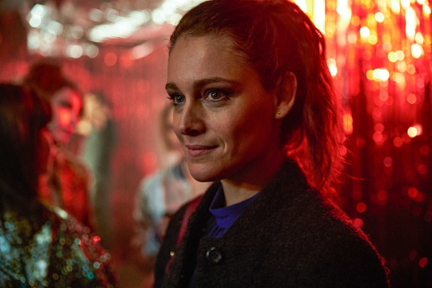 A young woman in a sparkly bar in the series Trigonometry