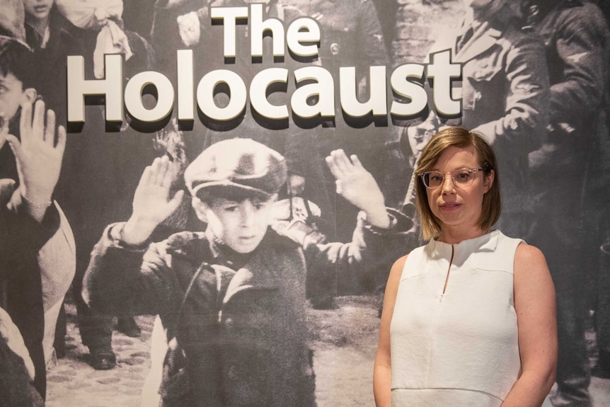 Inside Adelaide's new Holocaust museum, a woman stands in front of an historic photo.