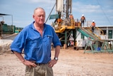 Farmer Ken Cameron standing in front of a drill risk on his property in Southern Queensland, February 2023.