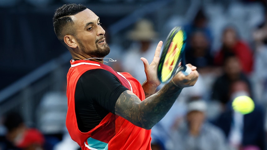 An Australian male tennis player plays a forehand at the Australian Open.