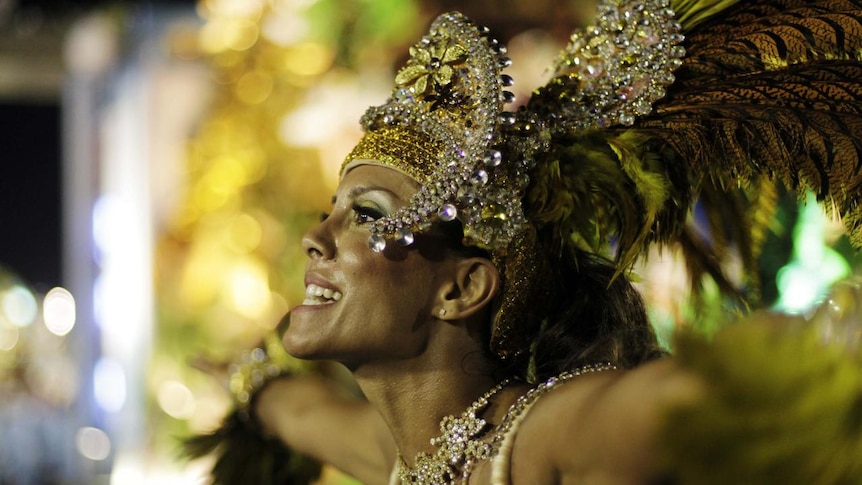 A woman with a sequined head dress dances during Rio de Janeiro's Carnival on March 6, 2011.