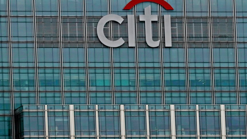A tall building with white letters that say Citi with a red line over top of it.