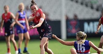 A female player receives the football during an AFL match.