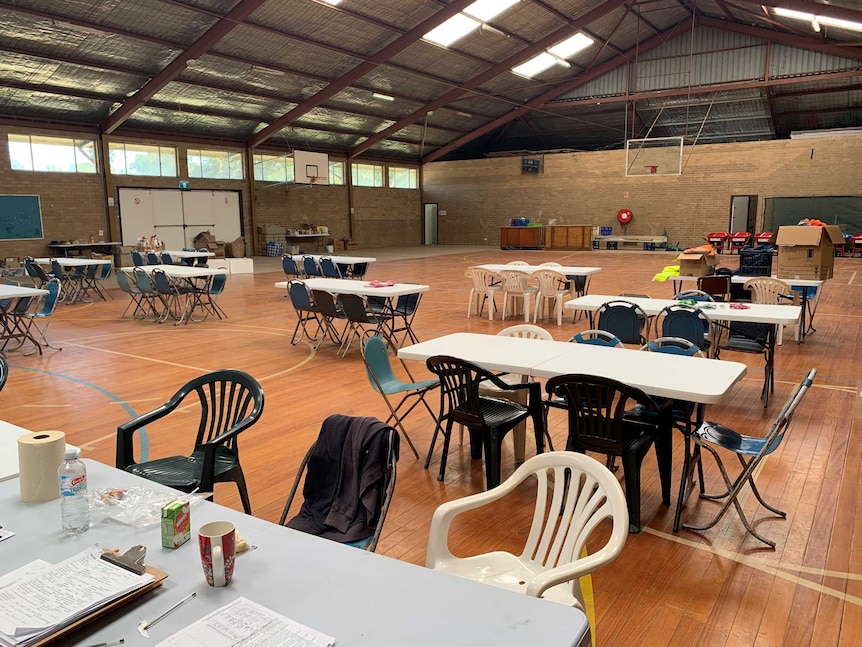 A basketball stadium with table and chairs set up