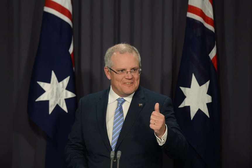 Scott Morrison stands at a lectern, speaking.