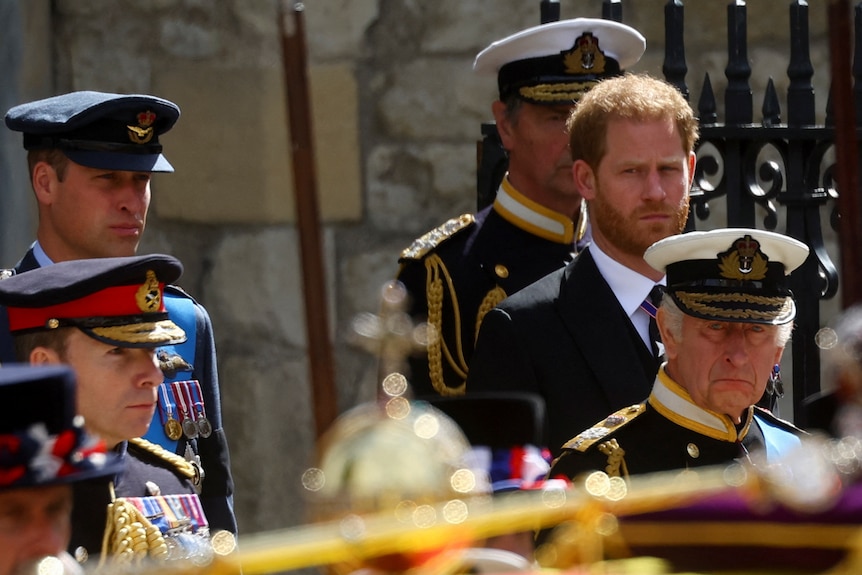 King Charles appears emotional outside Westminster Abbey during the Queen's funeral. Prince Harry is behind him. 